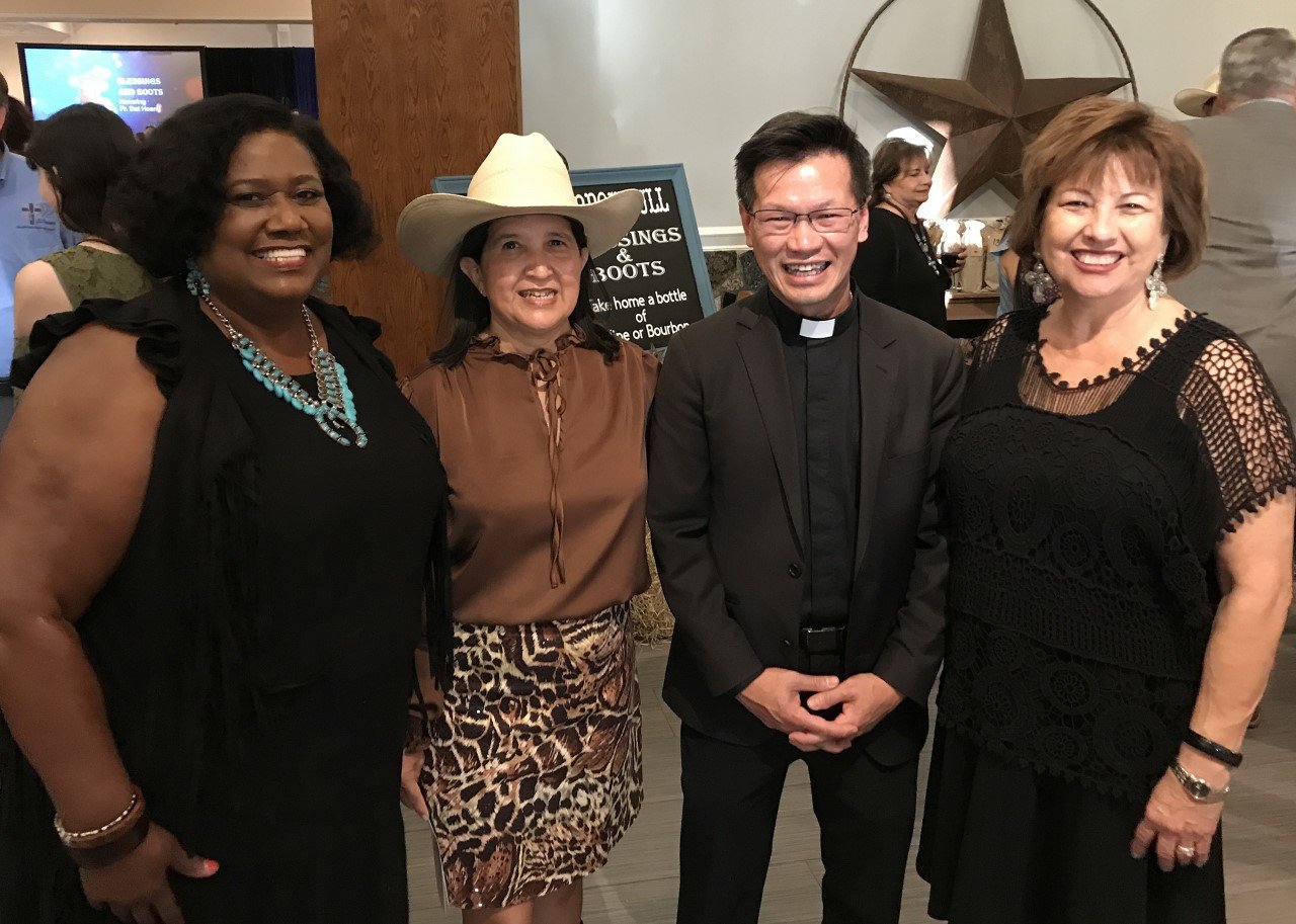 Mamie George Community Center Executive Director Gladys Brumfield-James, event co-chair Elilah Cavazos, Father Dat Hoang and event chair Elsa Poole prepare to kick up their heels at the “Boots and Blessings”-themed Mission of Love gala.
